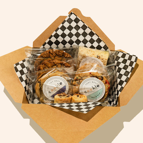 holiday gift box showing individially wrapped and stickered cookies